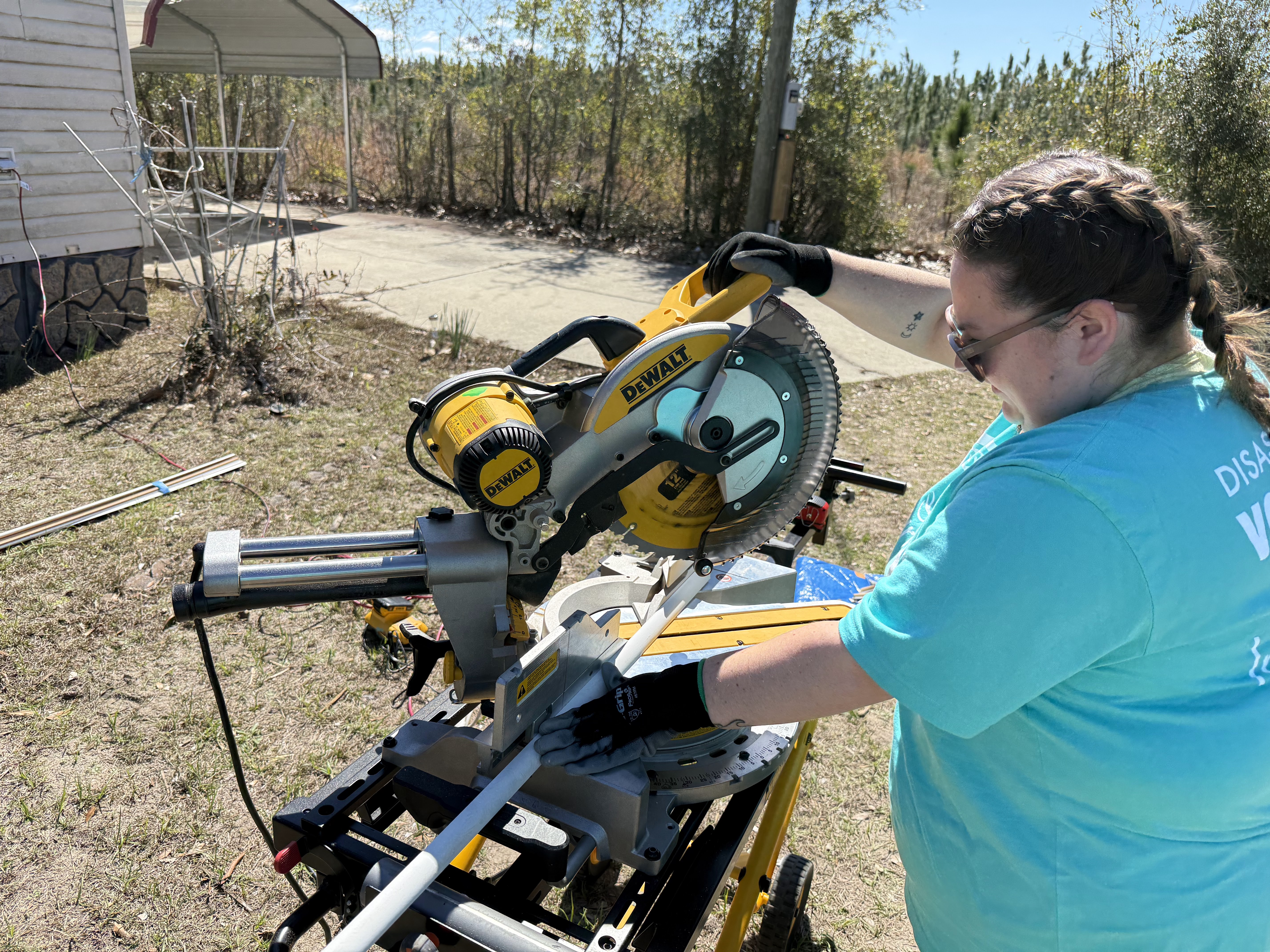 student volunteering in Georgia cutting wood