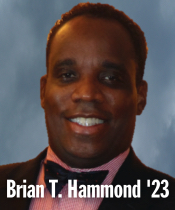 Headshot of person smiling wearing suit and bowtie