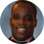 Headshot of person smiling wearing suit and bowtie