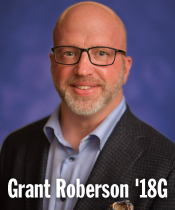 Headshot of a person wearing glasses, blazer and collared shirt