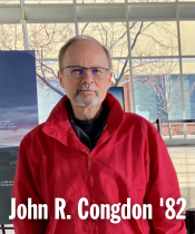 Headshot of a person wearing  glasses and a collared shirt