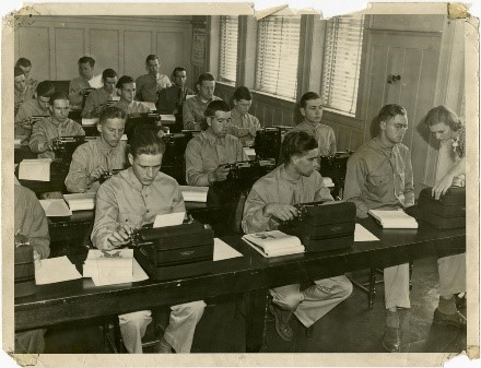 Students from Manchester air base siitting at tables, using typewriters