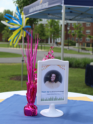 Framed picture of student on table with decorations outdoors