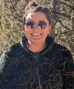 Headshot of person wearing sunglasses smiling