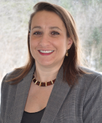 Headshot of person smiling wearing suit jacket