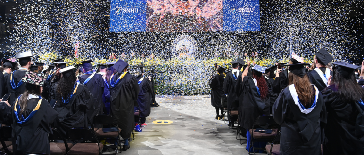 Crowd seated while confetti rains down at SNHU Commencement