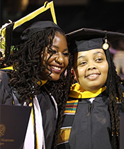 couple smiling for a picture together at graduation