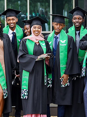 Group of GEM students in their caps and gowns at graduation