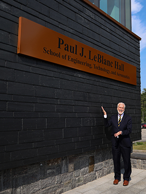 Paul J. LeBlanc standing in front of the SETA building that was re-named in his honor.