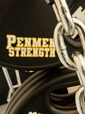 Workout equipment with 'Penmen Strength' written on it.