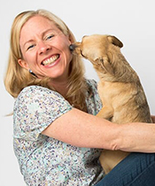 Woman smiling while dog licks her face