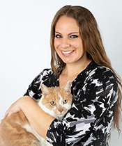 Woman smiling while holding a cat
